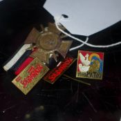 A First World War medal together with three Polish lapel badges
