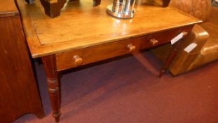 A rectangular fruitwood kitchen table with two frieze drawers raised on turned supports