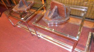 A pair of chrome low tables with inset square glass tops