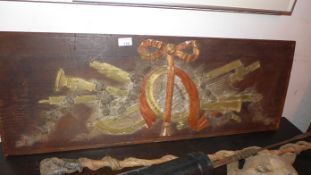 A Neoclassical oak panel with carved and painted instruments decorating it