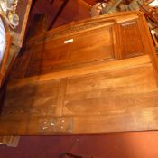 An Art Deco French mahogany double bedstead with carved floral detail in relief and with side rails