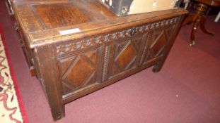 An C18th oak coffer of panelled construction and with carved detail
