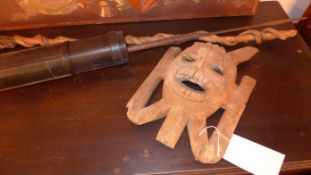 An African carved mask together with a ceremonial walking cane carved with an elephant an assegai