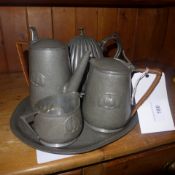 An Arts and Crafts pewter fine piece tea set and similar tea pot