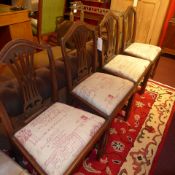 A set of four mahogany splat back dining chairs with drop in seats on stretchered supports