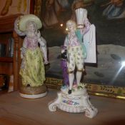 A Continental porcelain figure of a lady heightened in gilt and a similar candelabra (A/F)