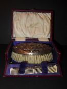 A C19th hallmarked silver clad brush and comb in original box