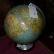 An early C20th German glass illuminating globe on wooden base