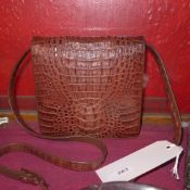 A ladies crocodile skin hand bag