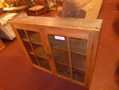 A bookcase section fitted pair of glazed panel doors