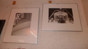 A pair of framed black and white photographs the first one depicting a waterfall the other depicting