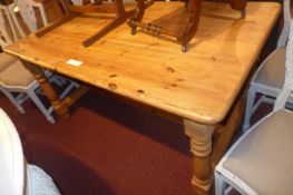 A pine refectory dining table the plank top raised on turned stretchered supports
