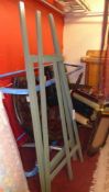 A pair of green painted easels of large size