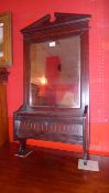 An Edwardian walnut wall mirror with broken pediment and rectangular plate