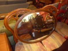 An Edwardian inlaid mahogany mirror with oval plate