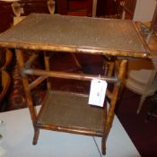 A Victorian aesthetic movement occasional table of rectangular form with an undertier