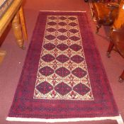 A fine North East Persian Zabir Belouch rug 230 cm x 110 cm repeating panel motifs on an ivory field