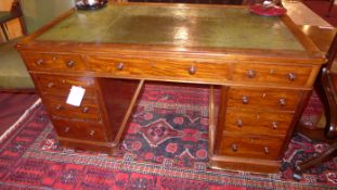 A Victorian mahogany pedestal desk the green tooled leather top above arrangement of drawers with