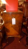 A burr walnut pot cupboard fitted single drawer and panel door on squat cabriole supports