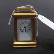 A gilt metal miniature carriage clock with Roman numeral dial