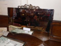 A 1940's  frameless mirror with bevelled plate