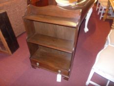A mahogany waterfall style open bookcase with base drawer