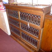 A C19th oak Globe Wernicke design three tier bookcase with leaded glazed panel doors and fitted