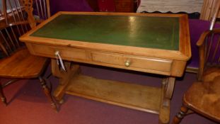 A Victorian pine side table with tooled leather top above two drawers on stretchered supports