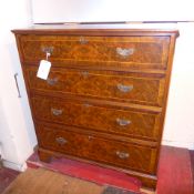 A Georgian style burr walnut and inlaid chest fitted four long drawers with brass plate handles on
