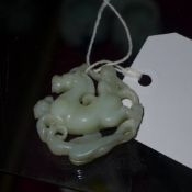 A Chinese jade carving of a monkey on horseback
