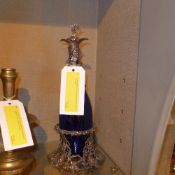 A pair of pewter and blue glass decanters with vine leaf detail