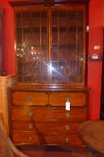 A George IV mahogany and crossbanded secretaire bookcase with astragal glazed pair of panel doors