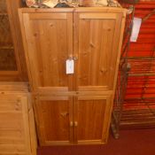A pair of contemporary pine cabinets fitted pair of panel doors enclosing shelves