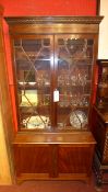 An Edwardian mahogany library bookcase fitted pair of cupboard doors on bracket feet