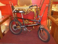An original 1970's two speed Raleigh Chopper push bike with black paintwork and chrome fittings