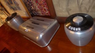 A retro American aluminium kitchen dispenser together with matching sugar and flour canisters (3)