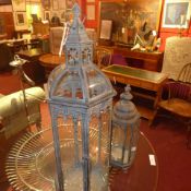 A pair of metal and glazed pagoda form hanging lanterns of graduating size