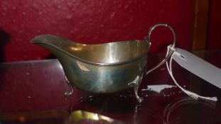 A hallmarked silver sauce boat on pad feet