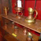 A collection of copper and brass bound mugs and the matching spirit kettle