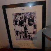 A framed Arsenal photograph of Alex James Eddie Hapgood and George Male leading out the team at