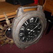 A distressed finish wall clock in the form of an oversized wristwatch