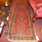A fine North West Persian Sarouk Mehal runner 295 X 80 cm repeating floral motifs on a terracotta
