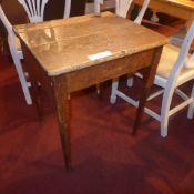 An old pine school desk raised on turned supports and pad feet