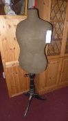 A vintage tailors dummy raised on turned column and tripod supports