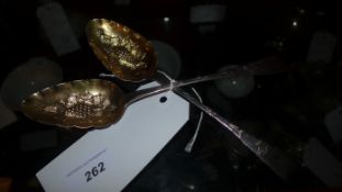 A pair of Georgian hallmarked silver berry spoons with embossed decoration