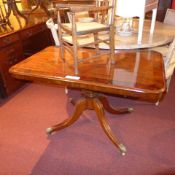 A Regency mahogany centre table the rectangular tilt top raised on pedestal base and quadruped
