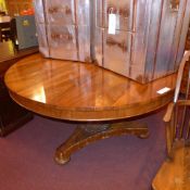 A C19th rosewood breakfront table the circular top raised on carved column and triform platform.