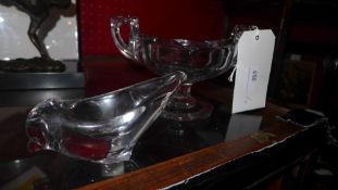 A cut glass twin handled bowl and a glass model of a dolphin on frosted glass base