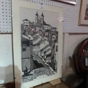 A framed woodblock print of a town on a hill