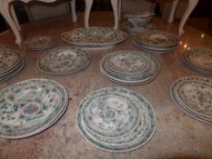 A Chinese famille vert porcelain export ware part dinner set including a sauce boat an oval